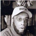 Headshot of Gary N. gray in black and white with a baseball cap on.